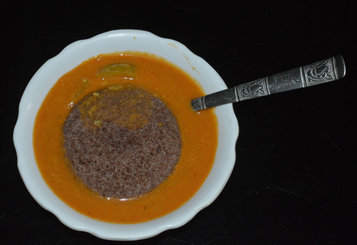 Ragi idli dipped in Indian sambar.