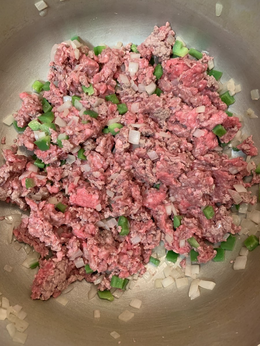 Saute your ground beef, onions, jalapenos, garlic, and bell pepper.