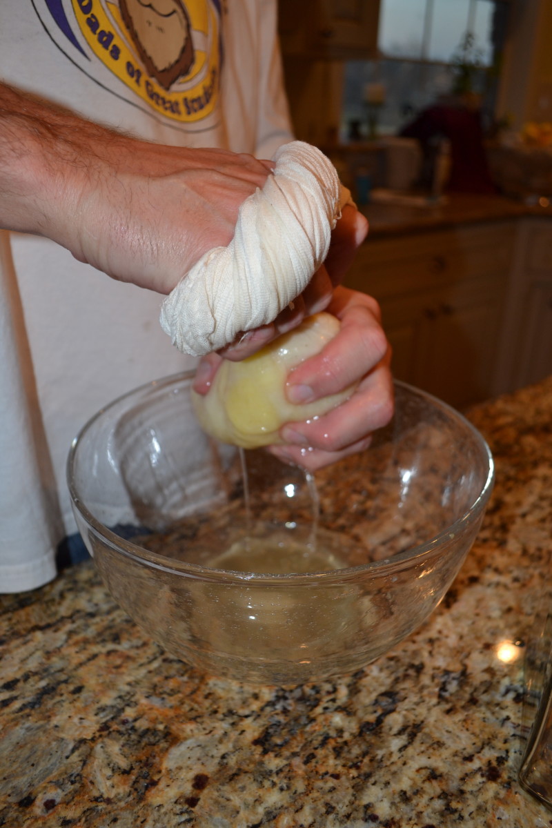 Step 7: Wrap the pineapple chunks in the cheesecloth and squeeze out any remaining juice and vodka.