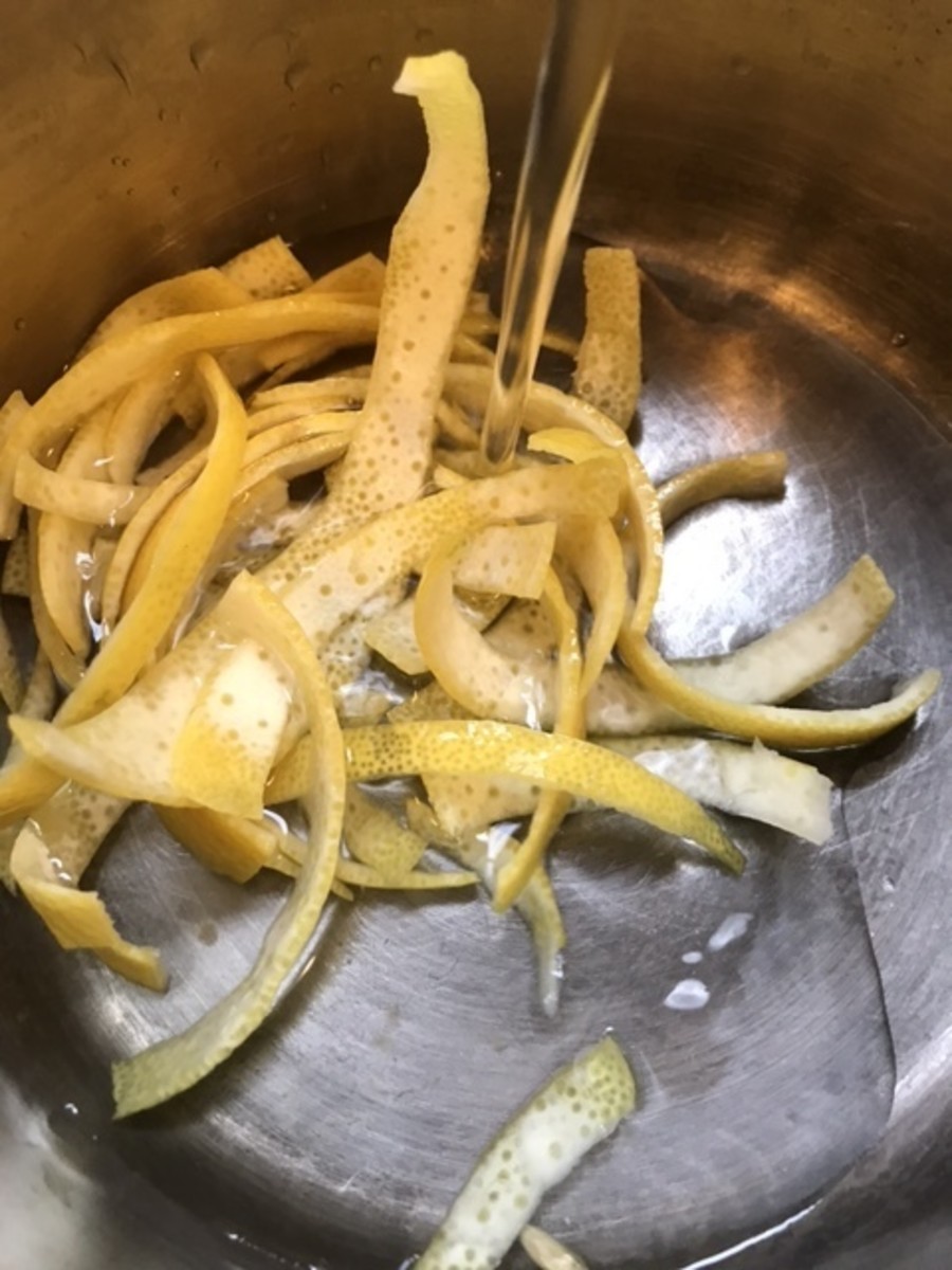 Place the lemon zest into a small saucepan and cover it with cold water. Bring this to a boil, drain completely, and repeat. You'll do this a total of three times.