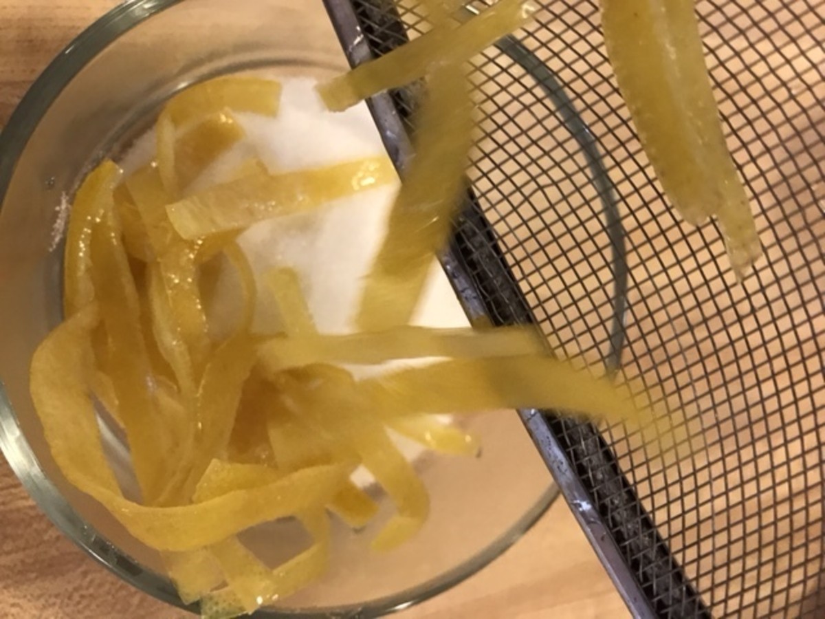 Once the lemon peels have drained, toss them with about half a cup of sugar. You don't need much - just enough to cling to the damp syrup on the outside of the candied lemon peels.