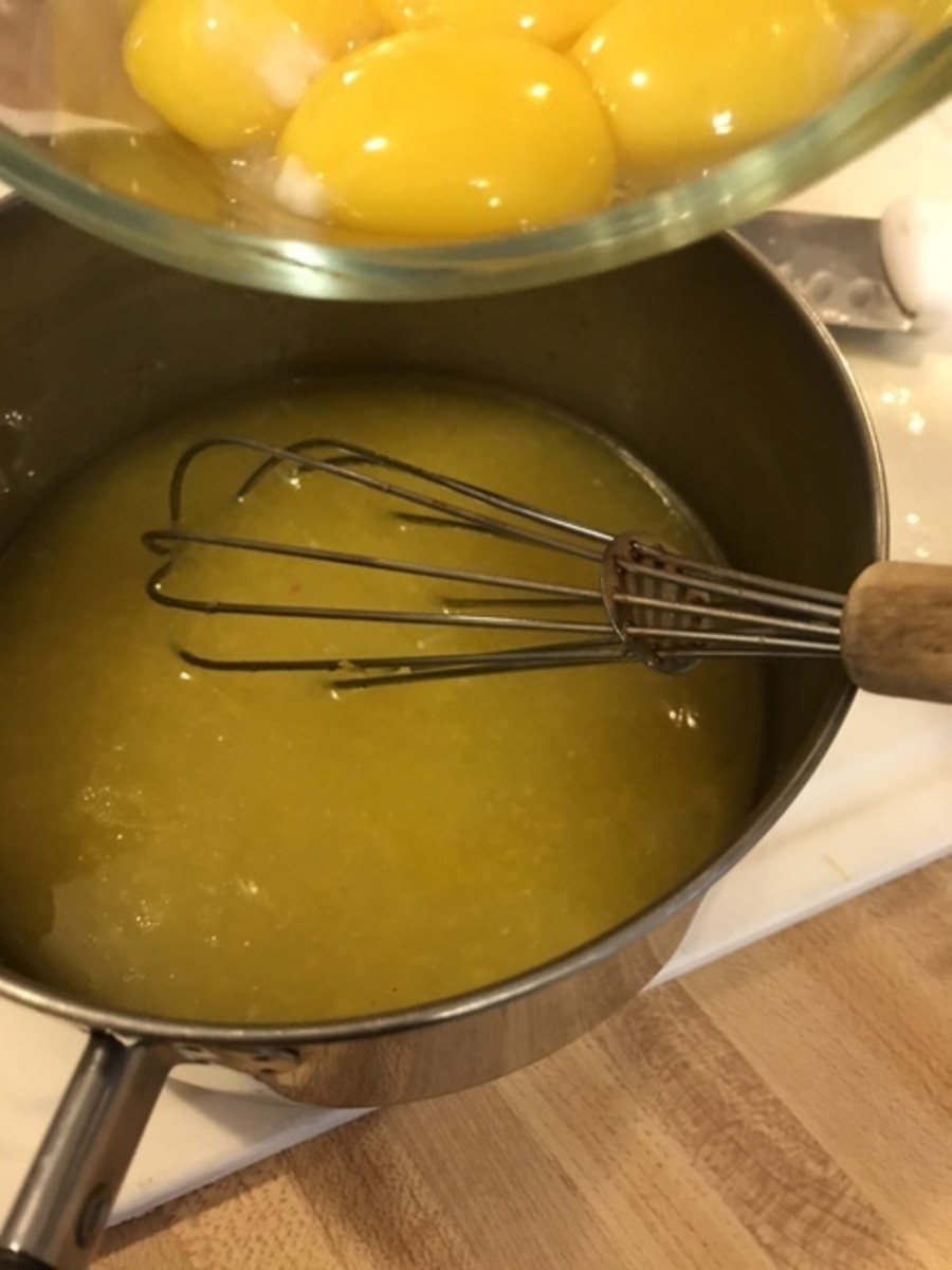 Stir the butter and sugar mixture well to fully incorporate the ingredients. Still working off the heat, add the eggs yolks and whisk well.