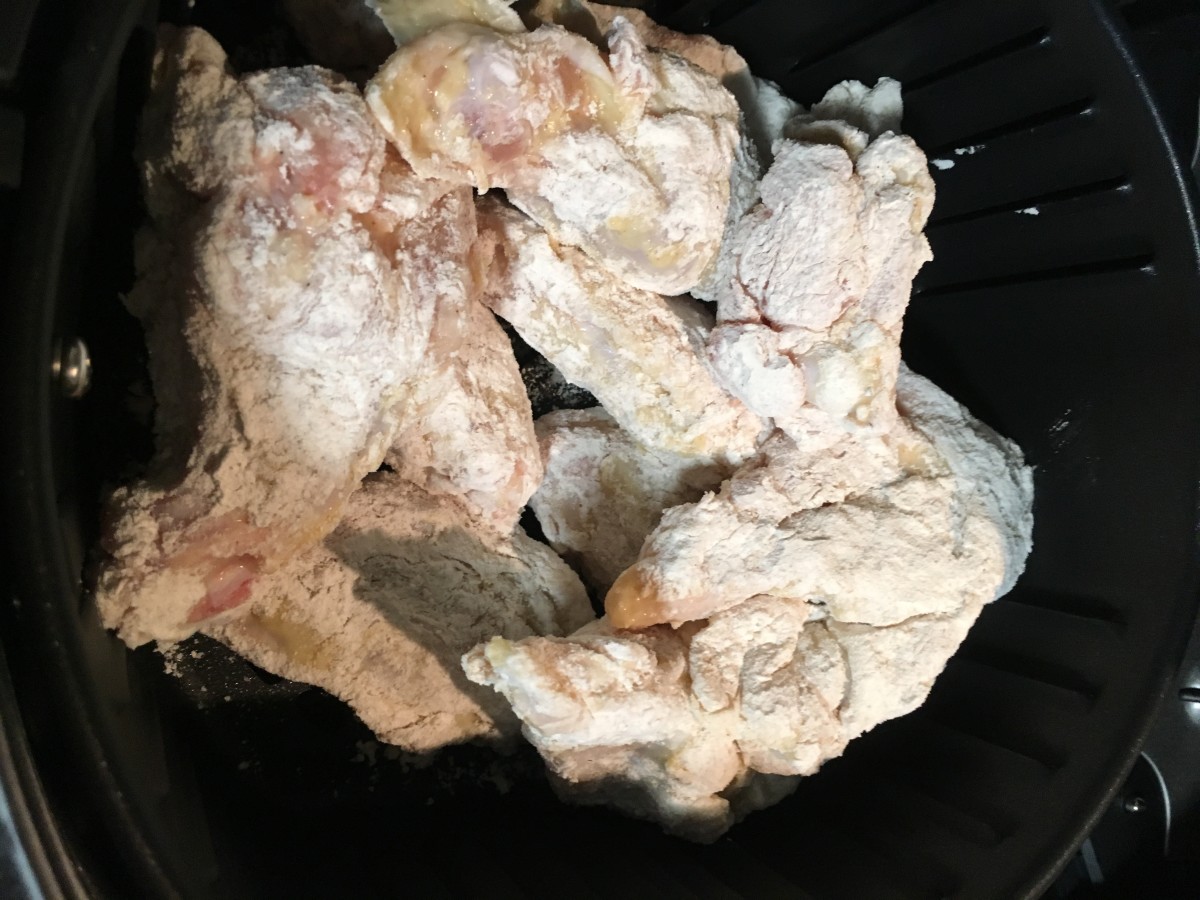 Breaded chicken in the fryer.