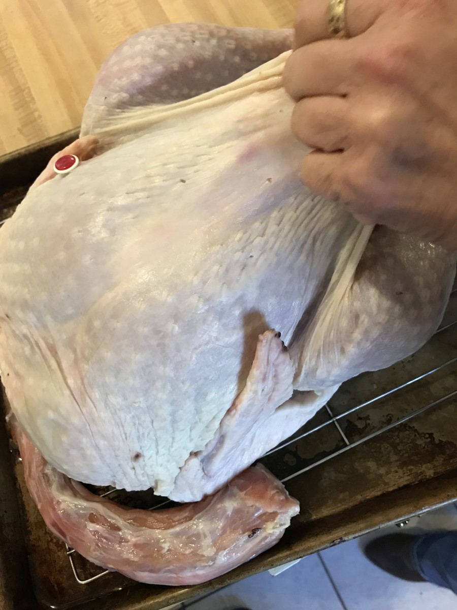 Loosen the skin of the turkey. Try to get as far down the turkey as possible, and over the tops of the legs. This lets the herb butter reach every last bit - and that's where the gorgeous flavor comes from.