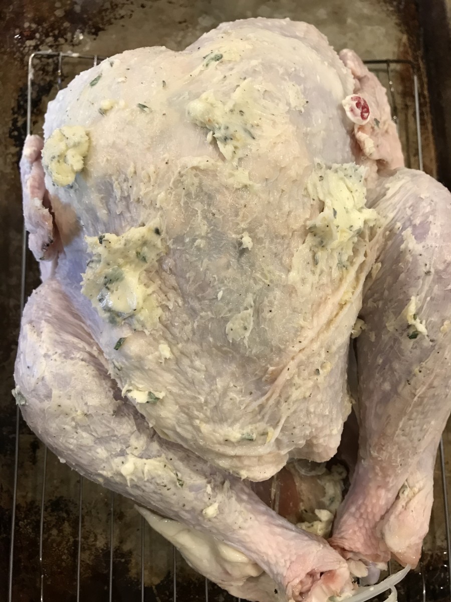 Ready for the Oven! Rub some of the herb butter over the exterior of the turkey. This helps get the skin crispy and beautifully golden brown.