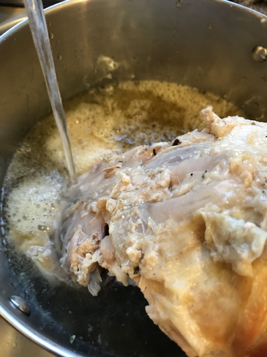 Once you've picked every bit you can from a turkey carcass, place it in a large stockpot and cover it with water. Try to use just enough water to barely cover - the finished broth will be richer and less diluted.