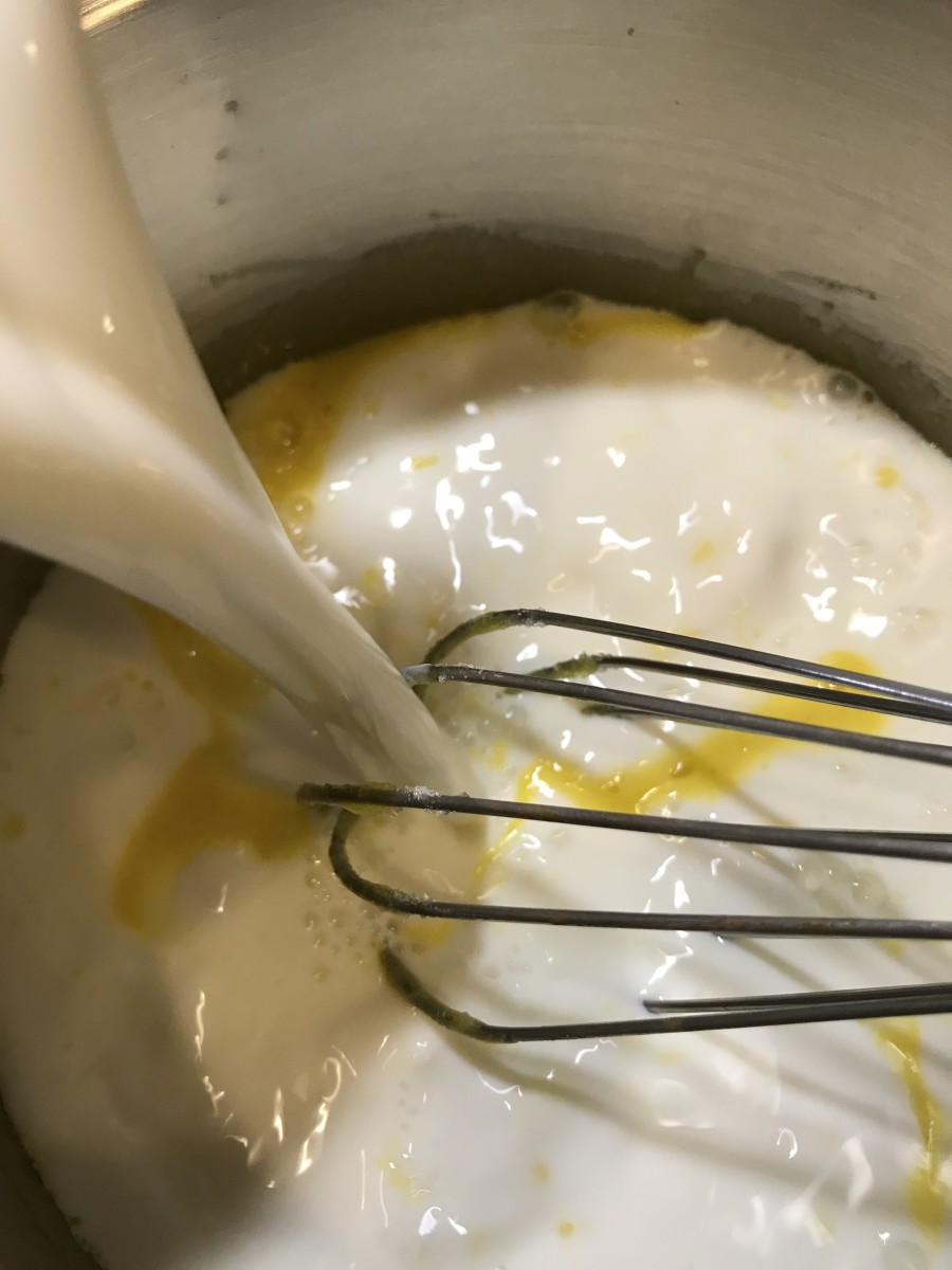 Whisk the egg yolks with the 1/3 cup of sugar, and turn the heat to medium. Stir in the milk, whisking well to make sure it's fully incorporated.