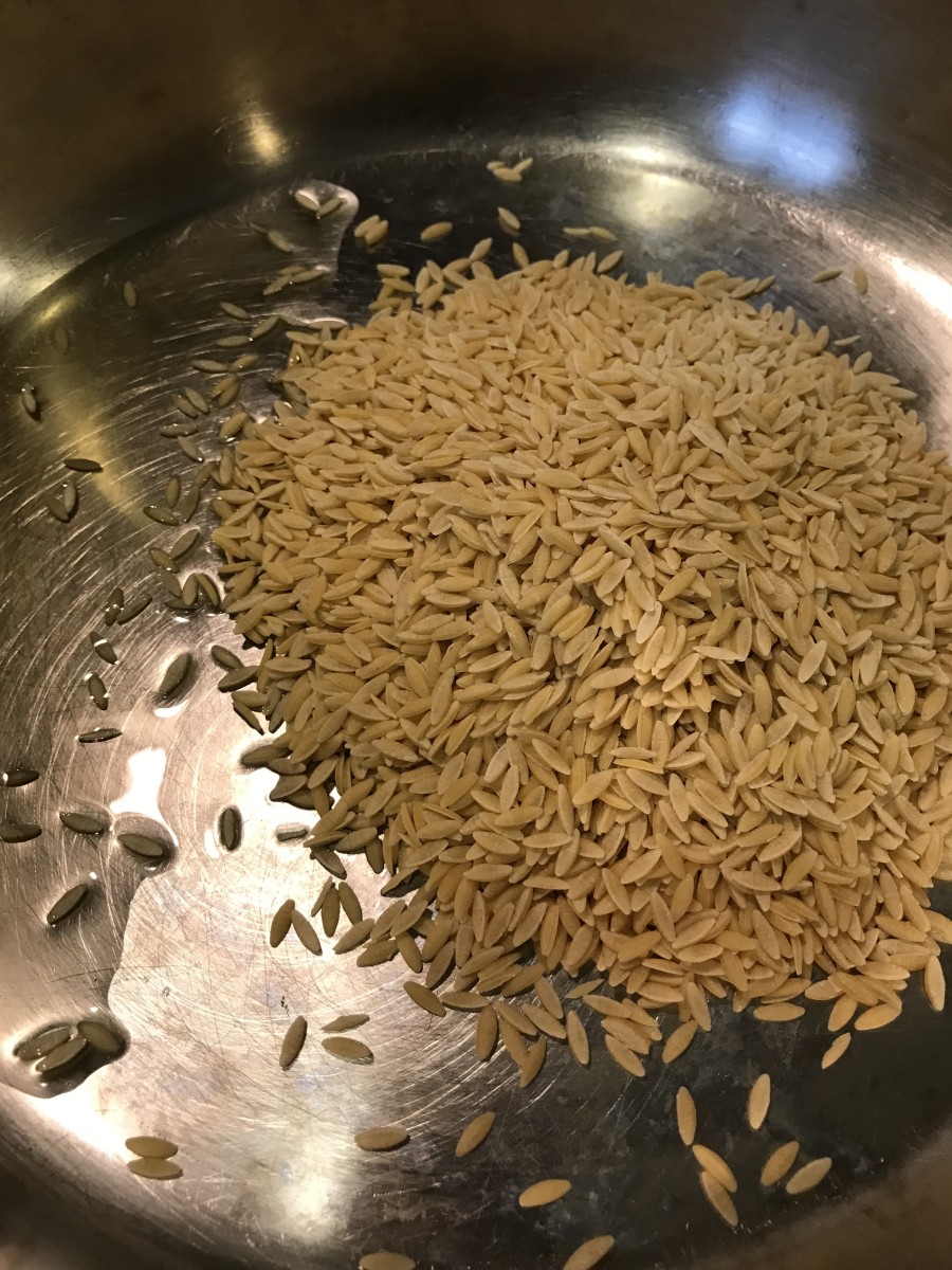 Heat the olive oil over medium heat, and toast the orzo. Stir it frequently while it toasts, especially toward the end. Once it starts getting a dark golden brown, add the rice.