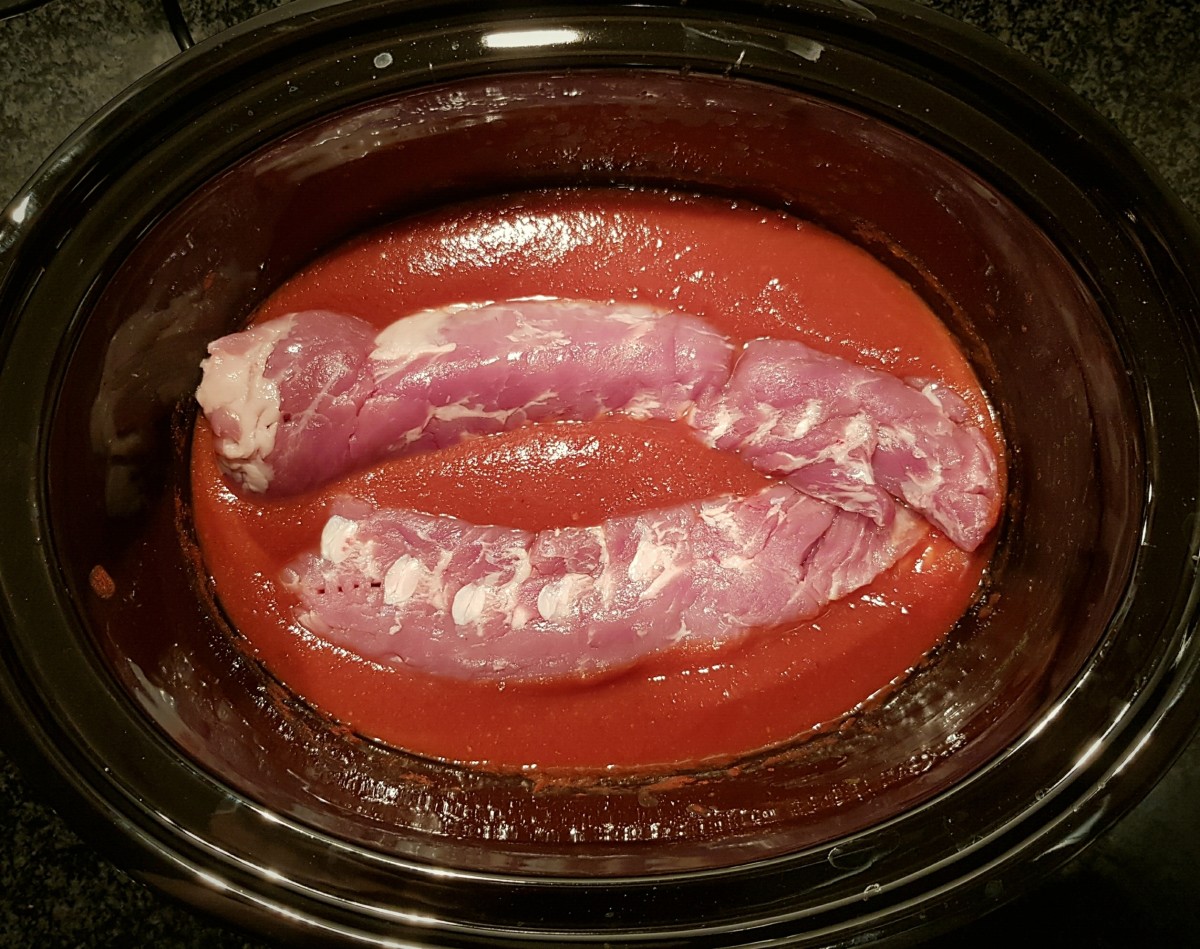pork cooking in sauce in a slow cooker
