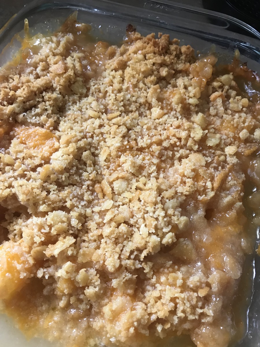 The finished pineapple casserole - the sauce bubbles up around the buttery cracker topping, creating a finished dish that's very much like a traditional cobbler, with a savory and salty touch.