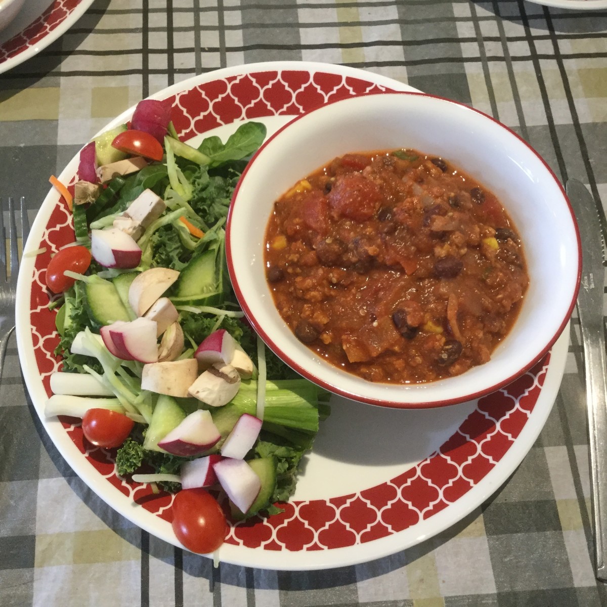 Vegan chili served with a green salad.