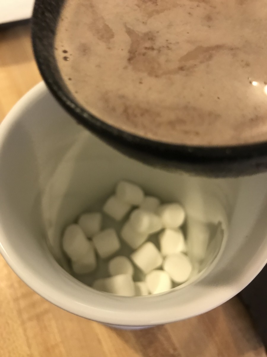 Ladle the hot chocolate into the cup over the top of the marshmallows. This lets the marshmallows get coated and start to get nice and squishy, which is the most beautiful state for a marshmallow.
