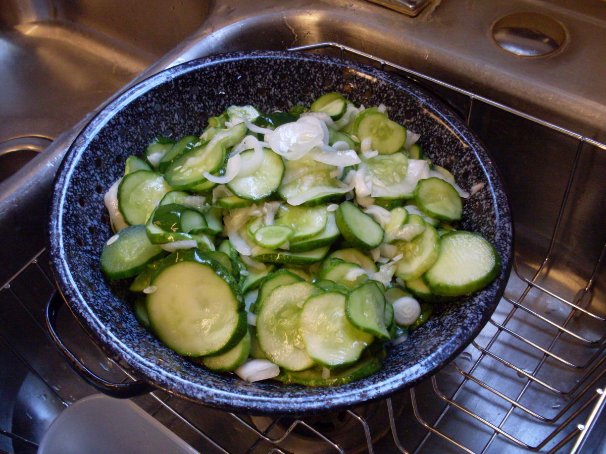 Dump cucumber slices from crock or bowl into collander to drain a few minutes.