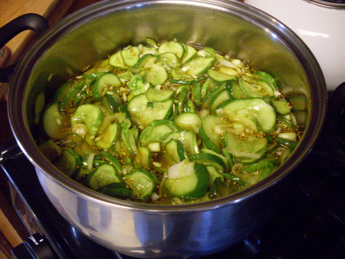 Add cucumbers, onions, and peppers, and heat thoroughly, but do not boil. 