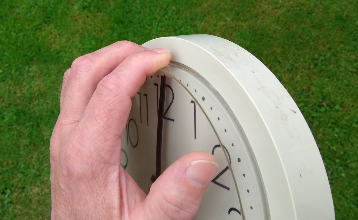 You can detach the lugs of the front cover of some clocks by pushing down with your fingers and pulling out at the same time.