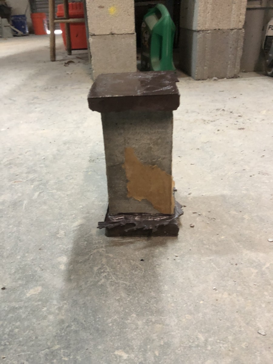 This grout prism has been capped with sulfur mortar on its ends so it has a smooth and level surface; the ends will be the points of contact for the break machine to compress the prism.