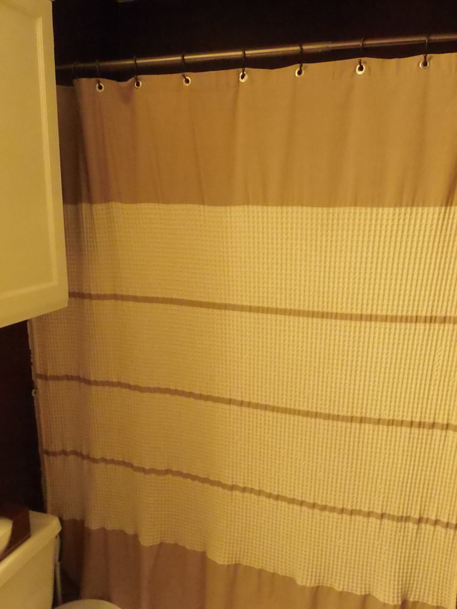 Waffle weave shower curtain adds a cozy warm texture to the bathroom.