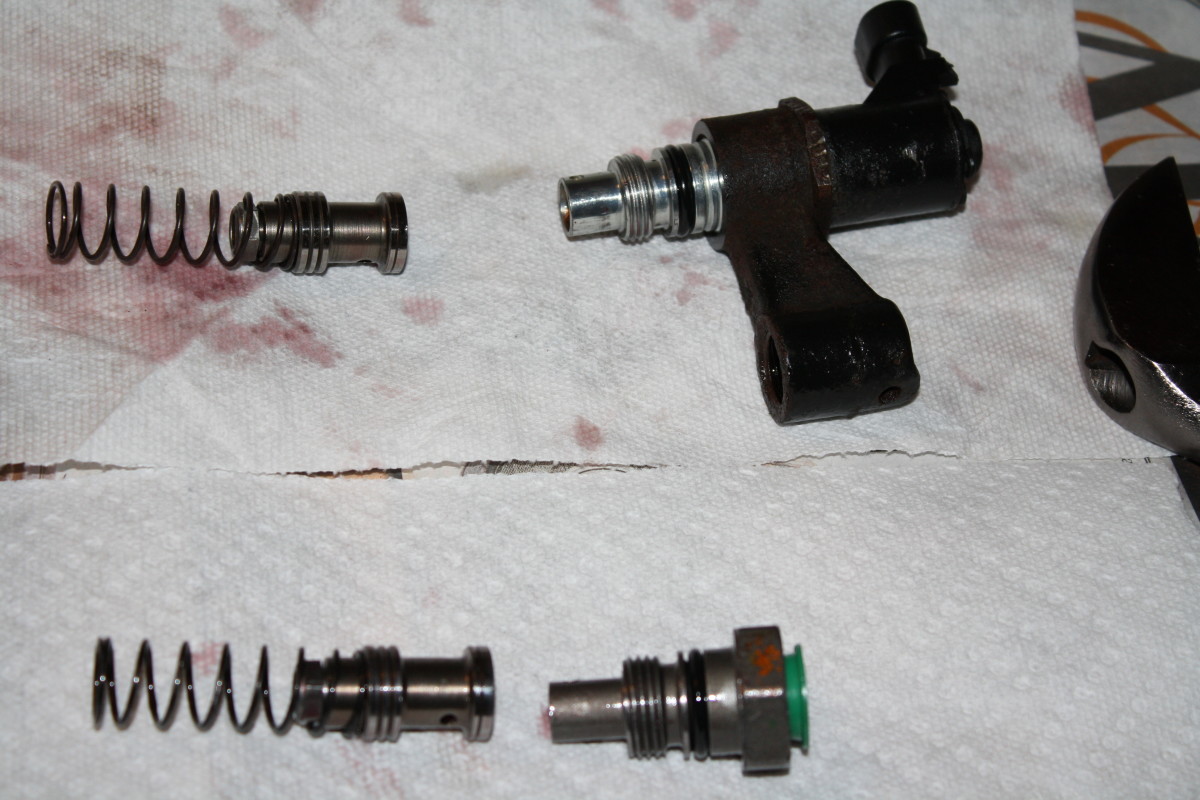 EVO and pressure relief valve from old pump (top) and new pressure relief valve and straight fitting from new pump.