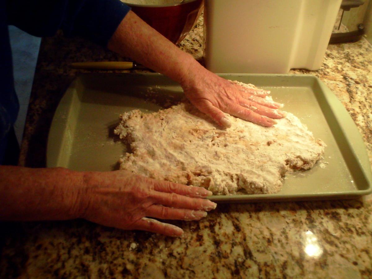 Spreading the dough on a cookie sheet.