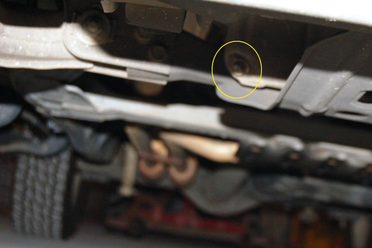 The oil plug faces the front towards the passenger side.