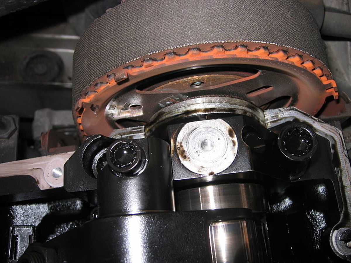 The timing belt is located under a cover at the front of the engine.