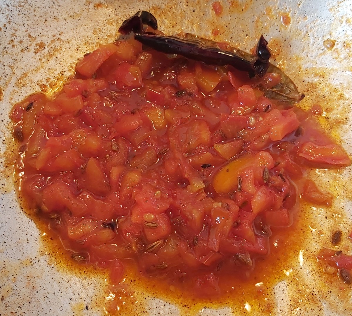 Mix everything and continue cooking till the tomatoes become tender and the chutney reaches the desired consistency. Adjust salt, jaggery and vinegar if required. Turn off the heat.