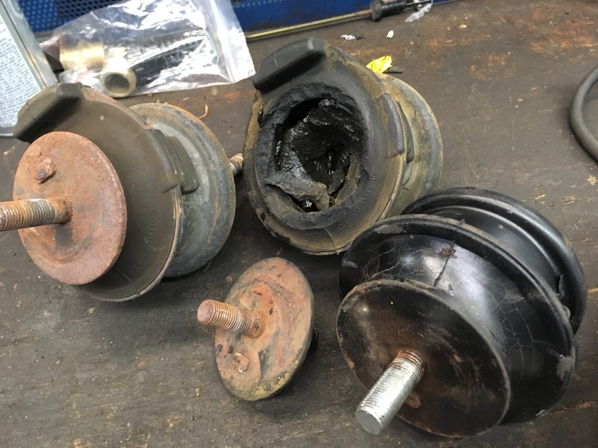 These are motor mounts that have failed. When a motor mount fails it can cause all kinds of knocking noises because nothing is holding the motor to the frame and the engine is flopping around in the engine bay. There's at least three more mounts.