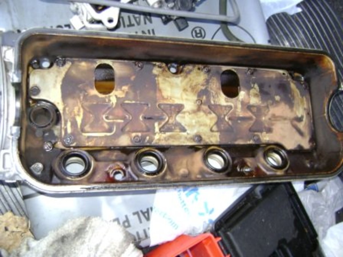 Valve cover before new spark plug gasket and valve cover gasket replacement.