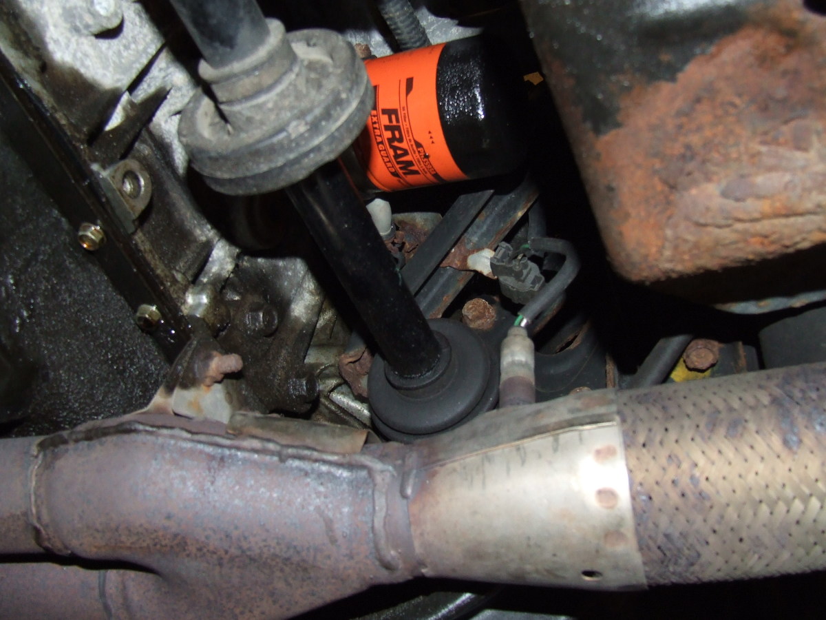 On this 1991 Honda Accord, you can see how the oxygen sensor (little rat-tailed item) is located directly below the oil filter. You can imagine how easy it is to dump oil on it.