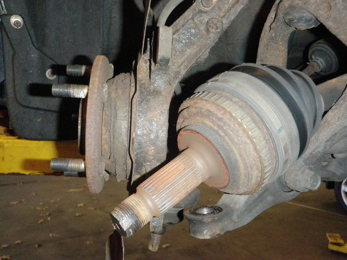Remove the axle nut and axle from the knuckle assembly.