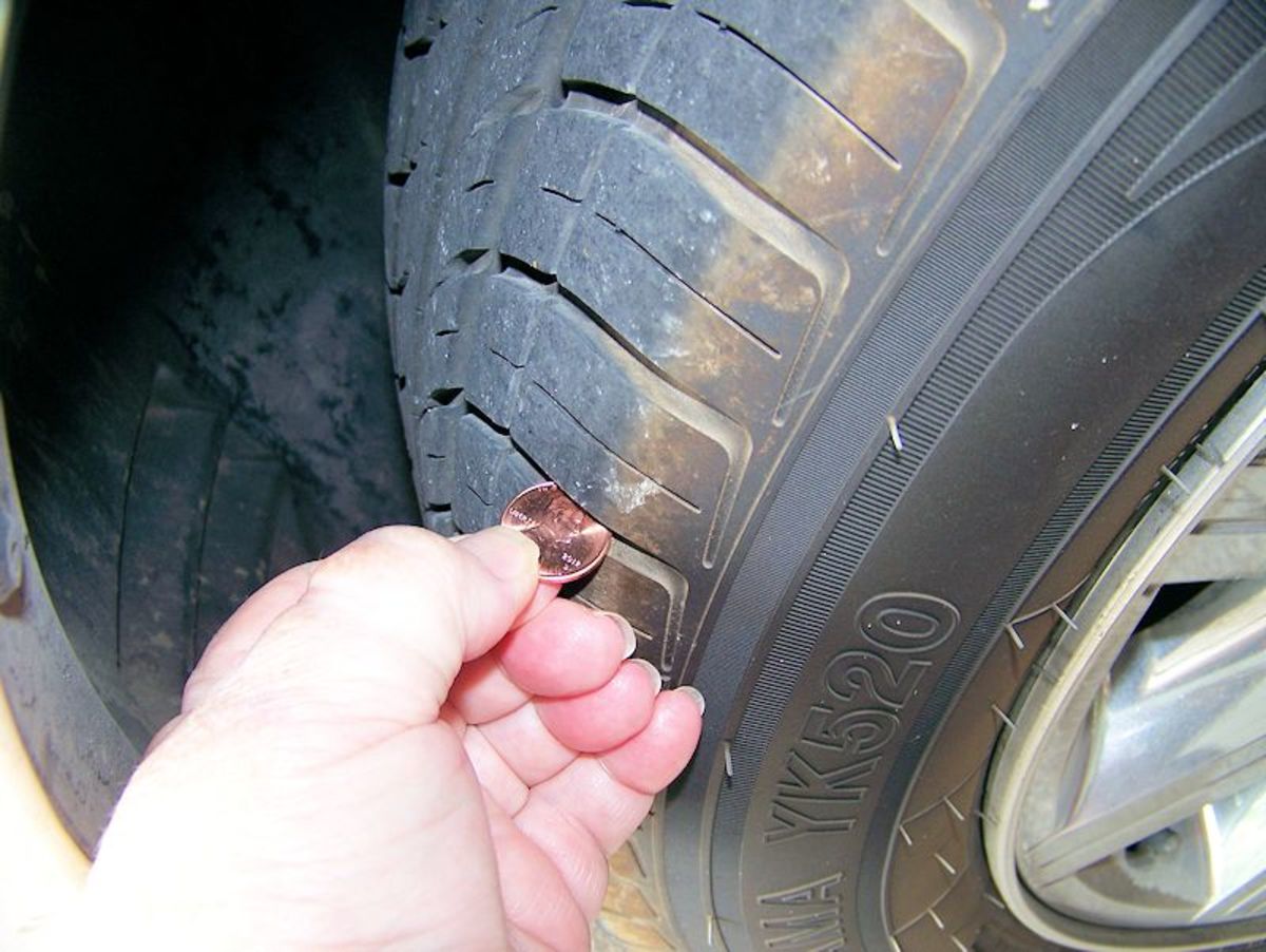 Insert a penny and if you can see the top of Lincoln's head, the car needs new tires. Tread depth needs to be 3 ml. or greater.