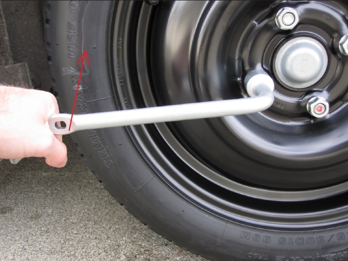 After lowering the jack, tighten the lug nuts.