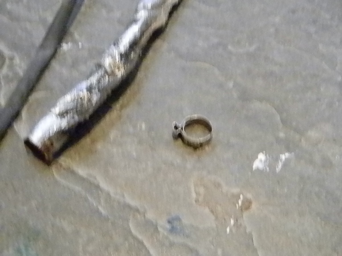 The ring (center) that holds the heat shield (in the upper right hand corner) to the oxygen sensor.