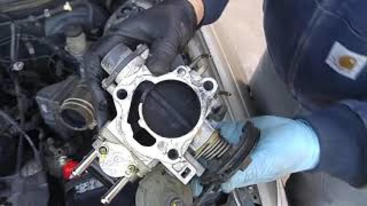 Removed Toyota 5SFE throttle body with carbonized throttle plate