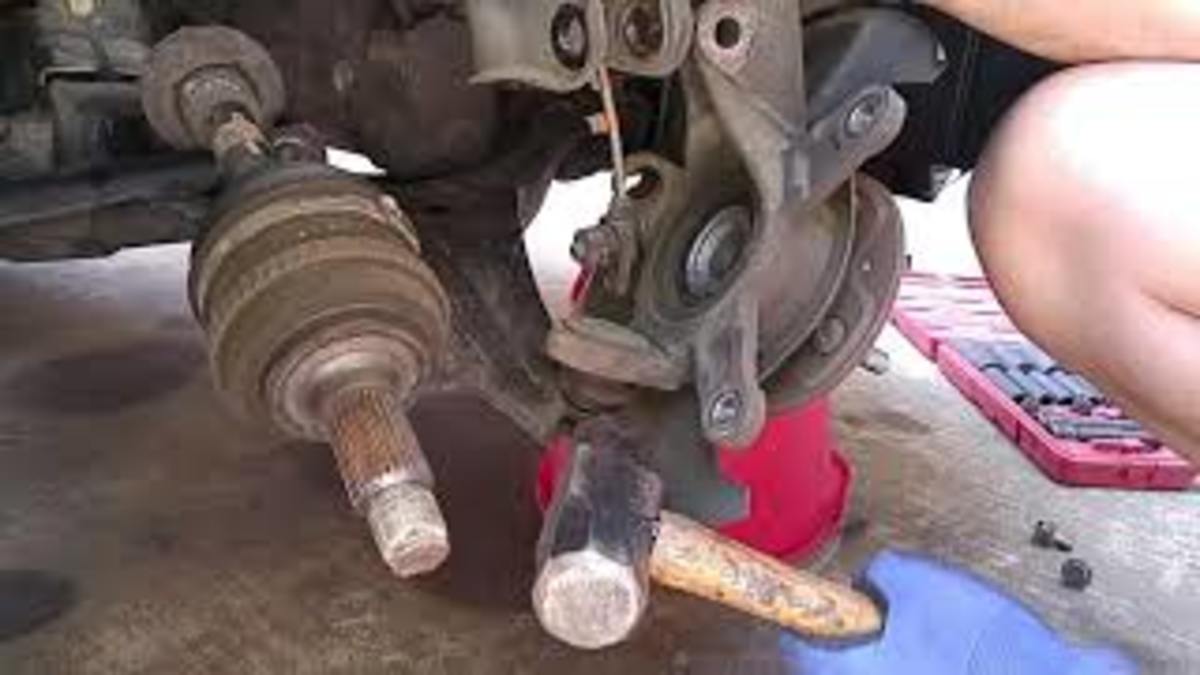Removing the Honda Civic steering knuckle from the suspension strut and lower control arm