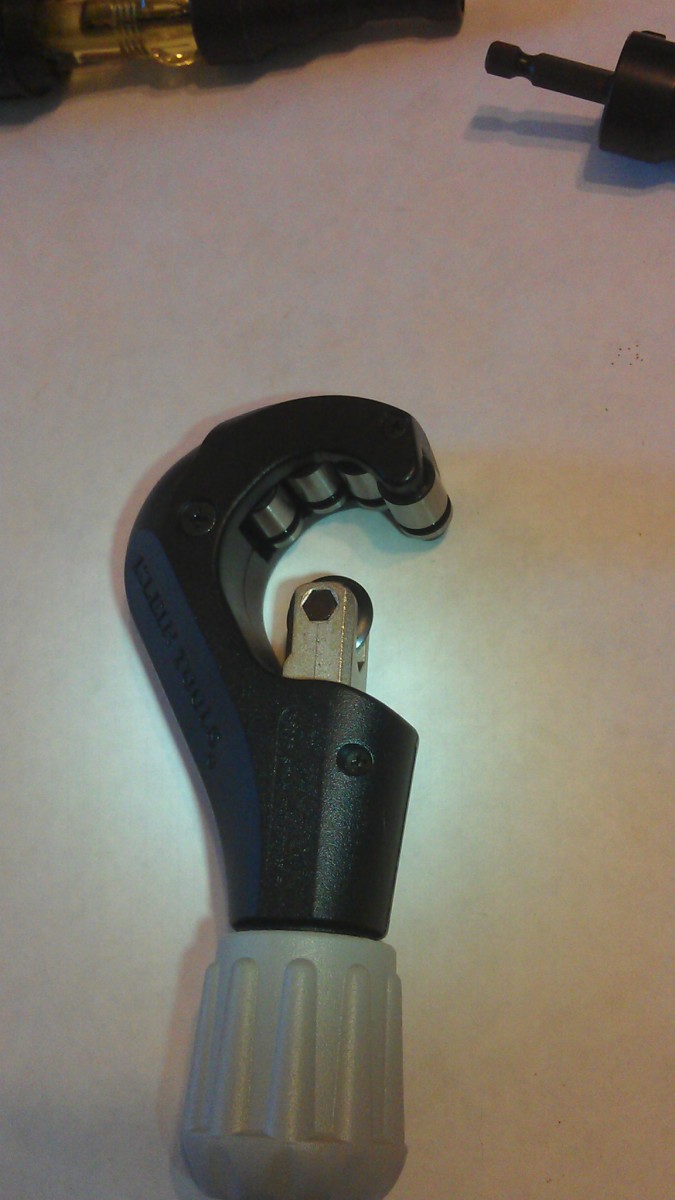 A tubing cutter for electrical conduit and other metal tubing