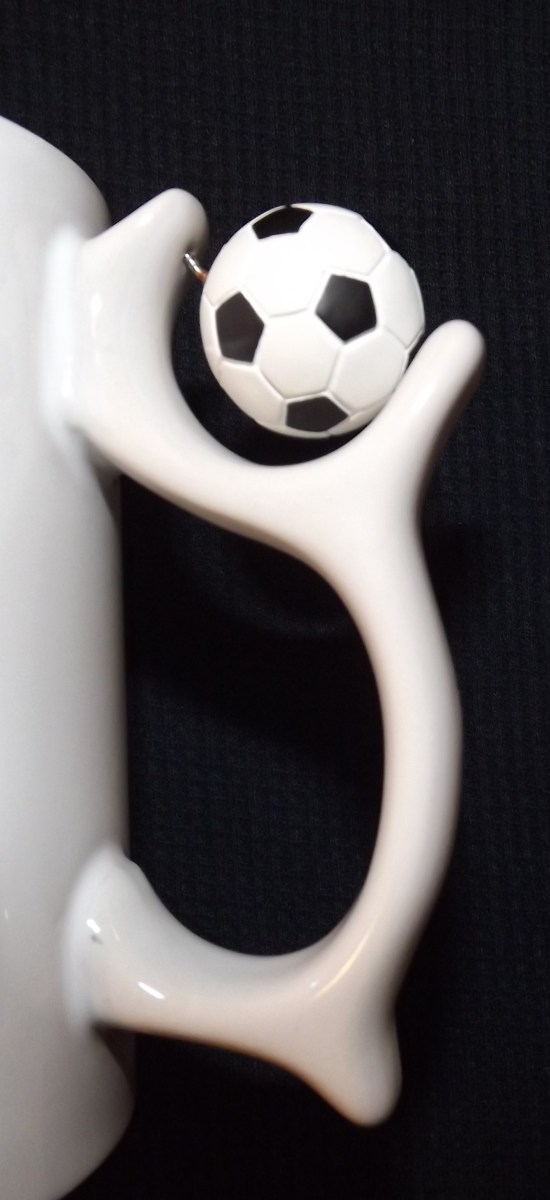Closeup of a Unique Spinning Soccer Ball on a Mug Handle