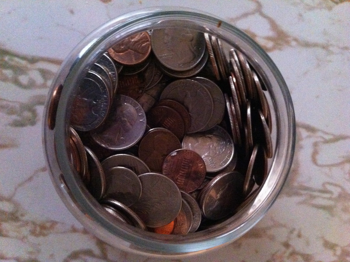 Coins almost overflowing from the change jar.