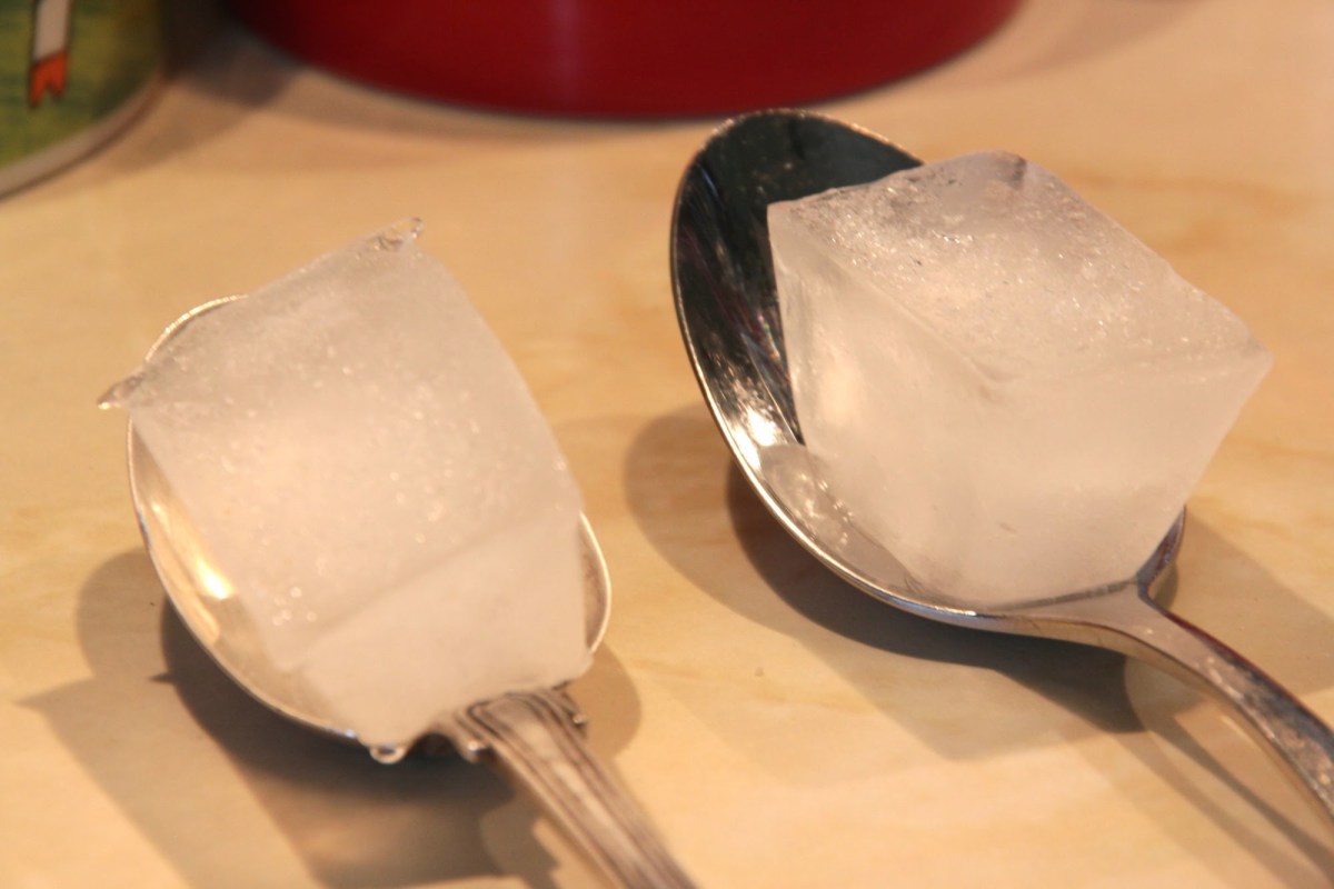 Ice test being applied on spoons. One is made of silver, the other is not.