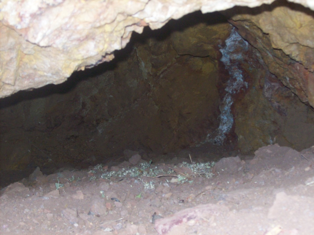 A cave or a mine entryway. Notice the vertical white streak. The tunnel extends to the left as far as you can see.