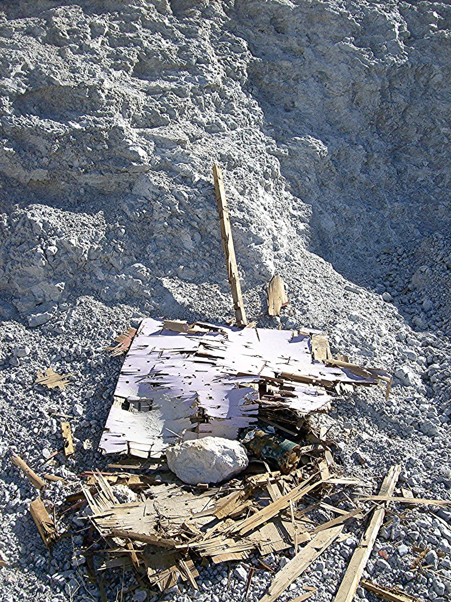 An old target that lies in front of a barrier formed by a wall of an abandoned open pit perlite mine. There are probably bullets behind and underneath it. An old target that lies in front of a barrier formed by a wall of an abandoned open pit perlite mine. There are probably bullets behind and underneath it.