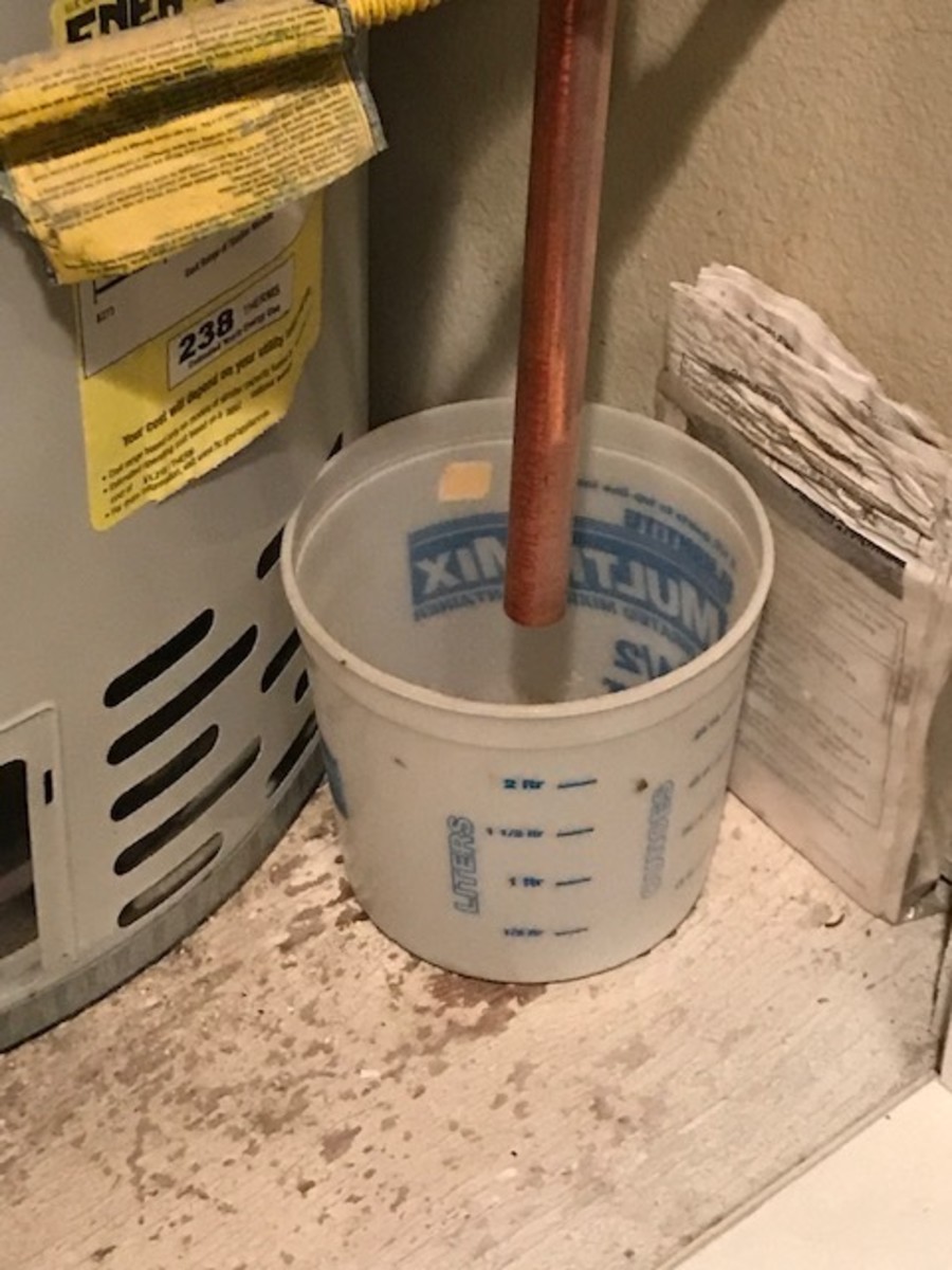 Water heater overflow draining to a bucket