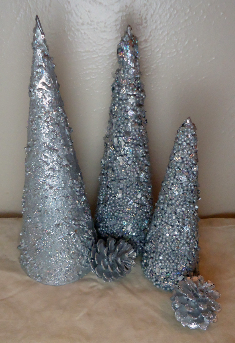 A few cone trees I made embellished with Styrofoam balls and glitter. The tall one is embellished with bath salt and glitter.