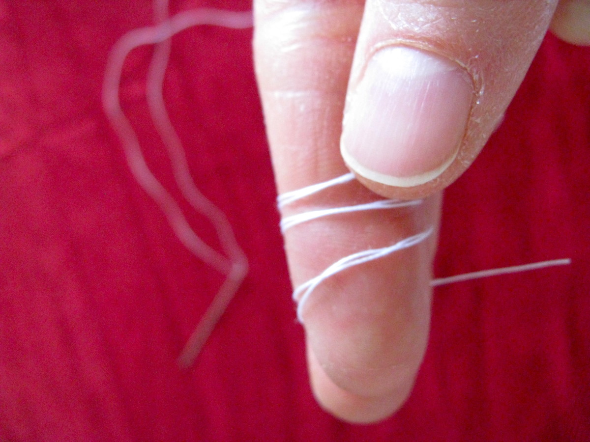Roll the damp thread on your finger to tangle it in itself...