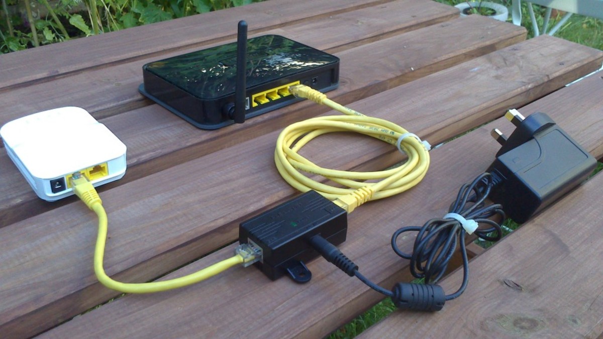 This picture shows an Open-Mesh router being powered using a Power over Ethernet injector (PoE).