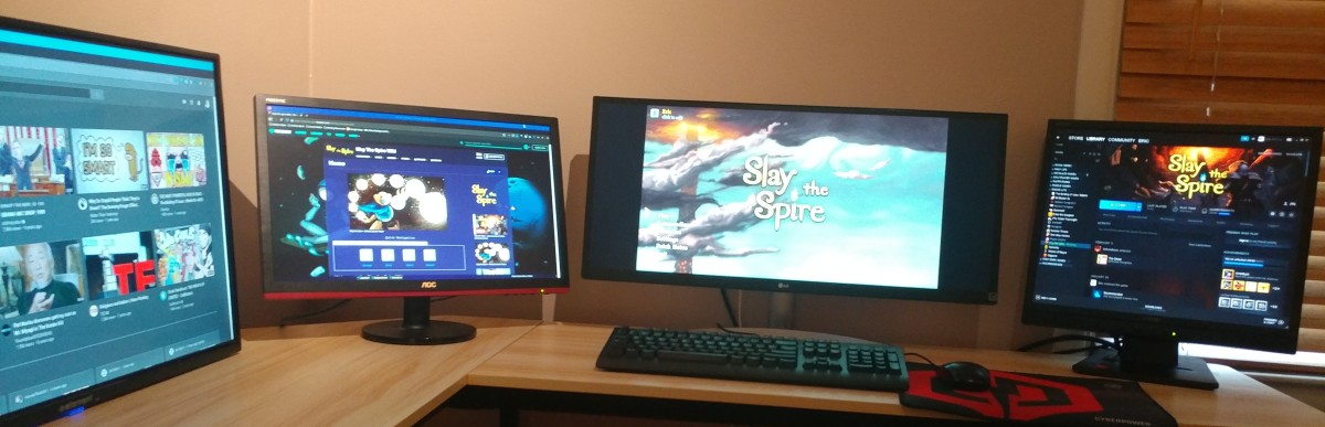 The game Slay the Spire on my main screen. The Slay the Spire wiki is open on the second screen. YouTube is open on the third screen. Steam is open on the fourth screen.