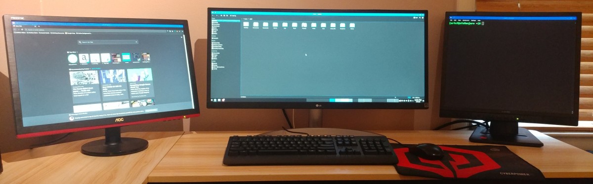 The Manjaro LInux file explorer is open on the main screen. Firefox is open on the second screen. The terminal is open on the fourth screen.