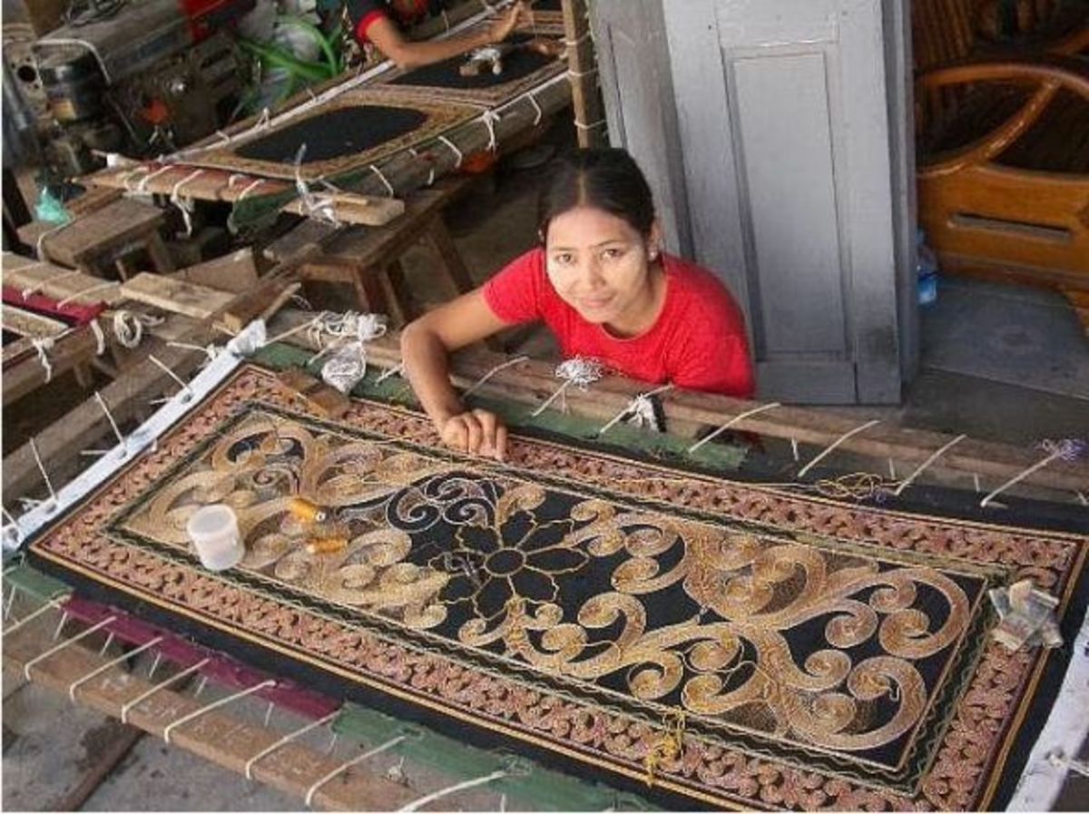 This artisan is finishing a kalaga tapestry.