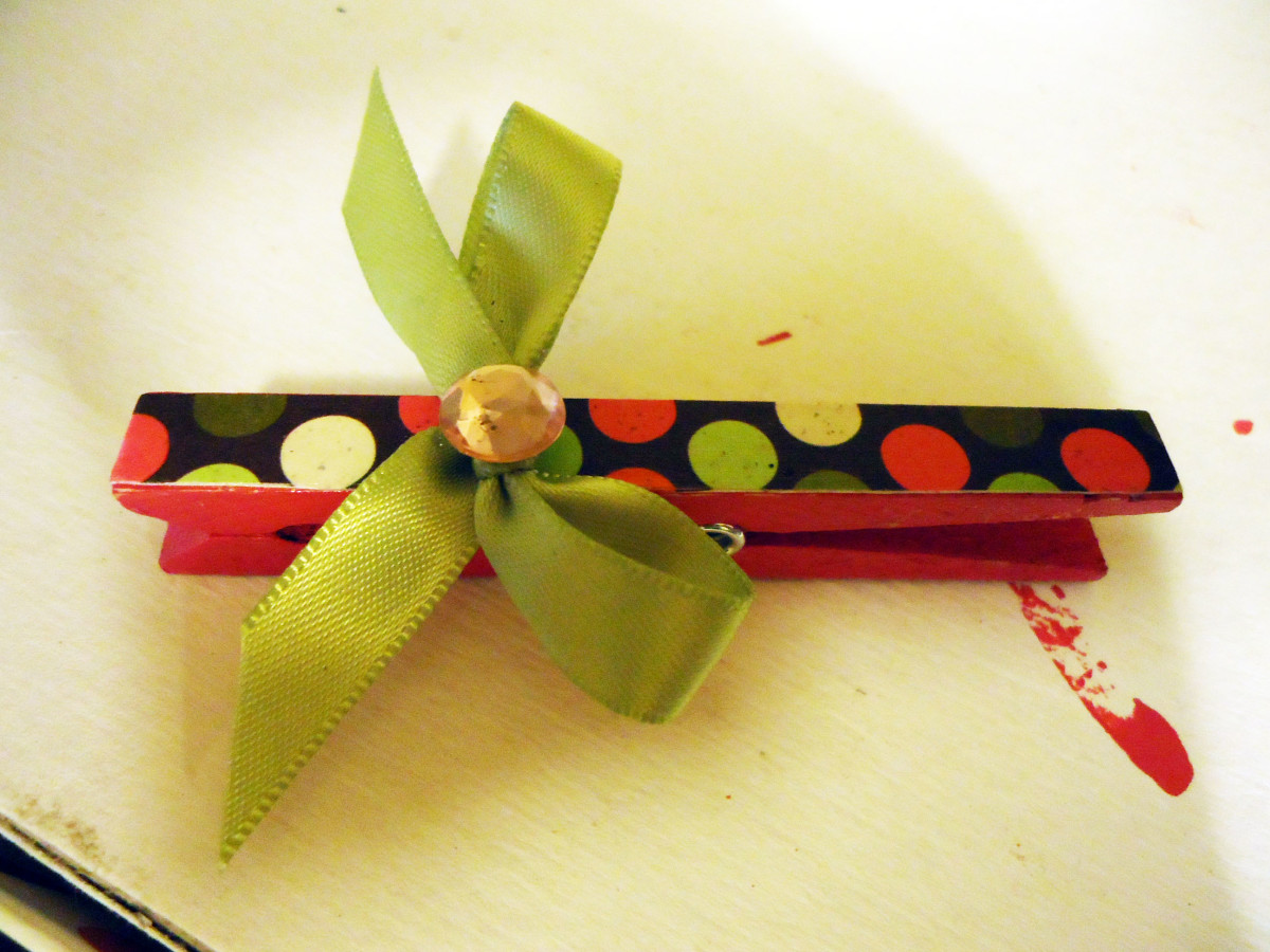 Clothespin embellished with a small bow and a rhinestone.
