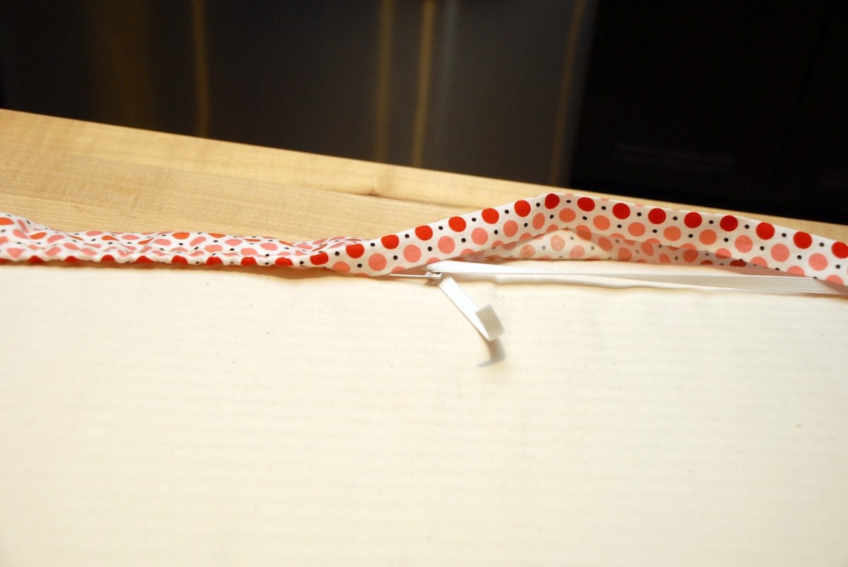 Safety pin the ends of the elastic together before you set your sheet down! 